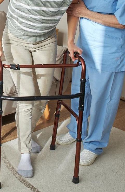 Elderly woman smiling with her physiotherapist